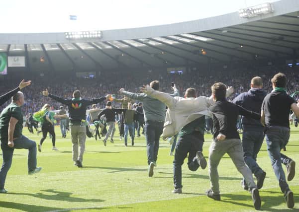 Hibs supporters invade the pitch at full-time. Picture: Greg Macvean