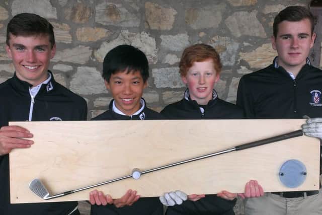 Four members of the MCS Golf Academy show off the trophy