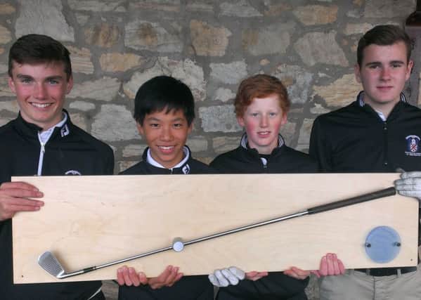 Four members of the MCS Golf Academy show off the trophy