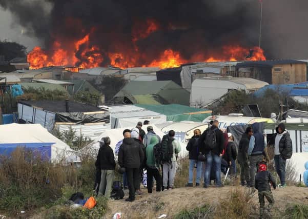 Fire breaks out in the Jungle camp as migrants prepare to leave . Picture:  Christopher Furlong/Getty Images