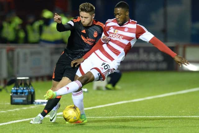 Aberdeen's Wes Burns, left, battles for the ball against Hamilton defender Lennard Sowah. Picture: SNS Group