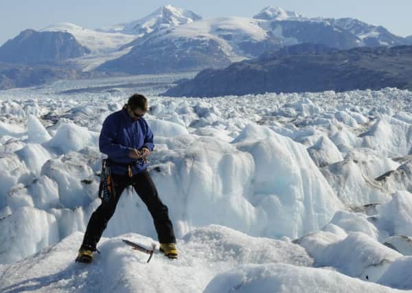 University of Maine professor Gordon Hamilton, in Kangerdlugssuaq Glacier, East Greenland. (Leigh Stearns via AP)