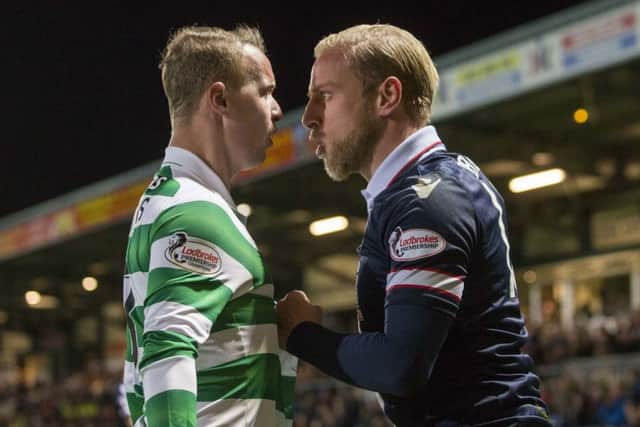 Ross County's Andrew Davies (right) and Celtic's Leigh Griffiths (left) exchange words during the match. Picture: PA