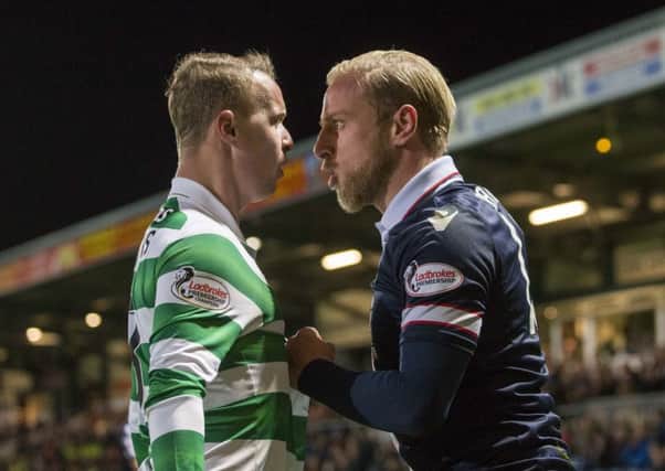 Ross County's Andrew Davies (right) and Celtic's Leigh Griffiths (left) exchange words during the match. Picture: PA