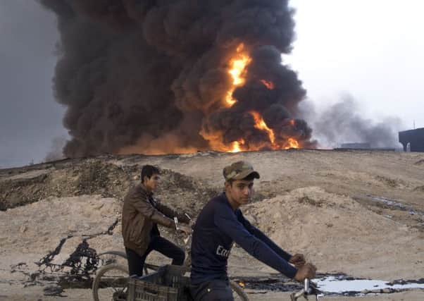 An oil well in Al Qayyarah burns after being set on fire by retreating Islamic State militants, releasing toxic fumes into the air. Picture: Marko Drobnjakovic/AP