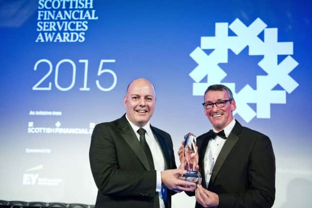 Royal Bank of Scotland head of entrepreneurship Gordon Merrylees, left, collects last year's award from Jim Duffy of Entrepreneurial Spark. Picture: Chris Watt