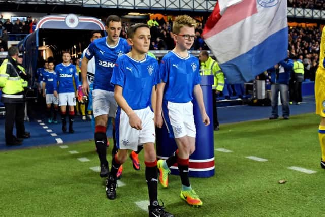 Young Rangers fan Kraig Mackay leads the teams out at Ibrox.
Picture: submitted