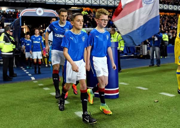 Young Rangers fan Kraig Mackay leads the teams out at Ibrox.
Picture: submitted