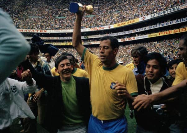 Carlos Alberto holds up the golden Jules Rimet trobpy after Brazil defeated Italy in the 1970 World Cup final. Picture: AP Photo/Gianni Foggia