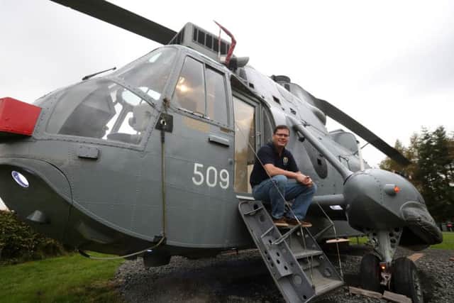 Stirling farmer Martyn Steedman sits on the steps of his retired Sea King helicopter. Picture: PA