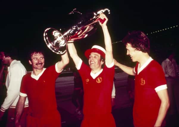 Tommy Smith, Ian Callaghan and Phil Neal of Liverpool parade the trophy after the 1977 European Cup Final. Picture: Getty