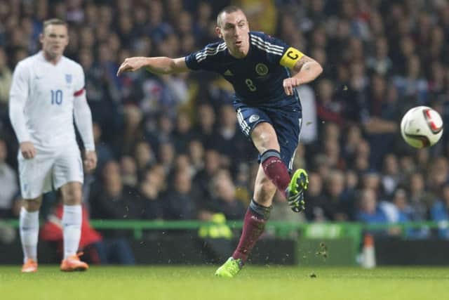 Scott Brown in action against Wayne Rooney and England during the friendly at Celtic Park in 2014. Picture: Craig Williamson/SNS