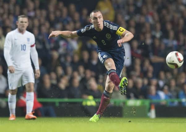 Scott Brown in action against Wayne Rooney and England during the friendly at Celtic Park in 2014. Picture: Craig Williamson/SNS