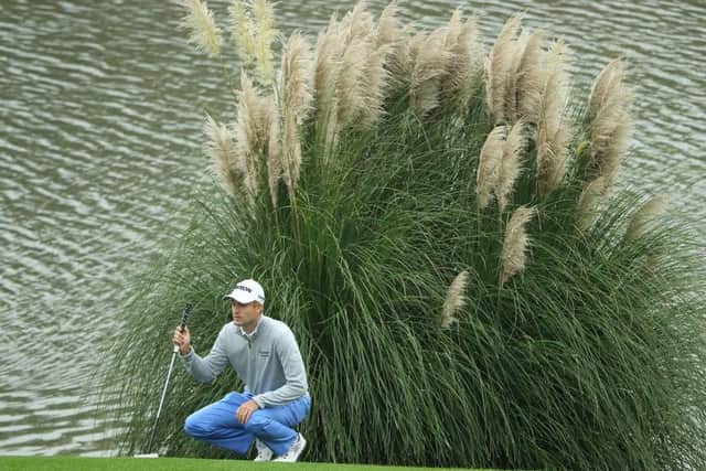 Russell Knox lines up a putt during his second round at Sheshan International. Picture: Getty.