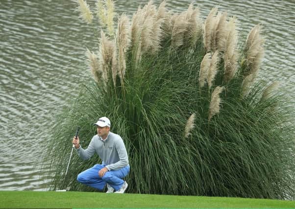 Russell Knox lines up a putt during his second round at Sheshan International. Picture: Getty.
