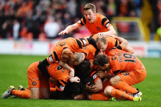 Mark Durnan is buried under his celebrating team-mates after scoring the games only goal.  Picture: Garry Hutchison/SNS