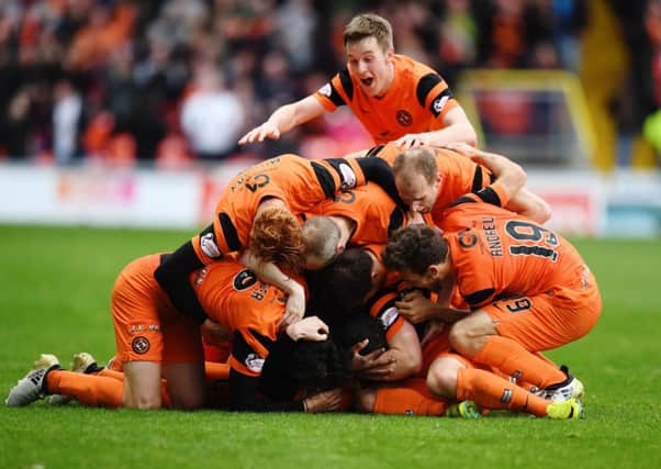 Mark Durnan is buried under his celebrating team-mates after scoring the games only goal.  Picture: Garry Hutchison/SNS
