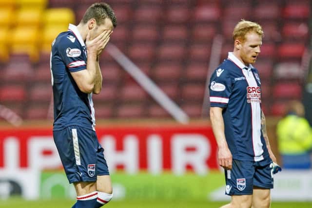 Ross County's Paul Quinn, left, and Chris Burke are left dejected after their 4-1 reverse against Motherwell. Picture: SNS/ Roddy Scott