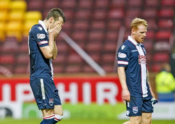Ross County's Paul Quinn, left, and Chris Burke are left dejected after their 4-1 reverse against Motherwell. Picture: SNS/ Roddy Scott