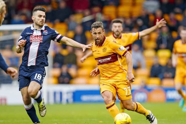 Scott McDonald, right, passes the ball under pressure from Ross County's Ian McShane. Picture: SNS