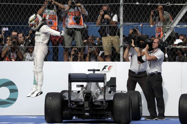 Lewis Hamilton celebrates after winning the Mexico Grand Prix at the Hermanos Rodriguez racetrack in Mexico City. Picture: AP