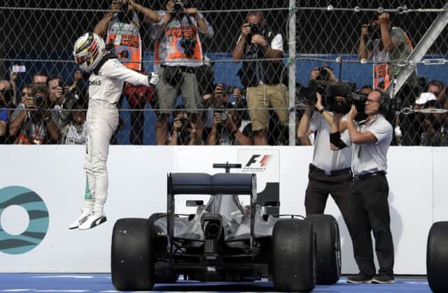 Lewis Hamilton celebrates after winning the Mexico Grand Prix at the Hermanos Rodriguez racetrack in Mexico City. Picture: AP