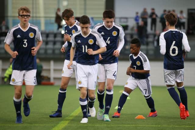 Karamoko Dembele, Scotlands No 7, goes through the warm-up with his team-mates. Picture: PA.