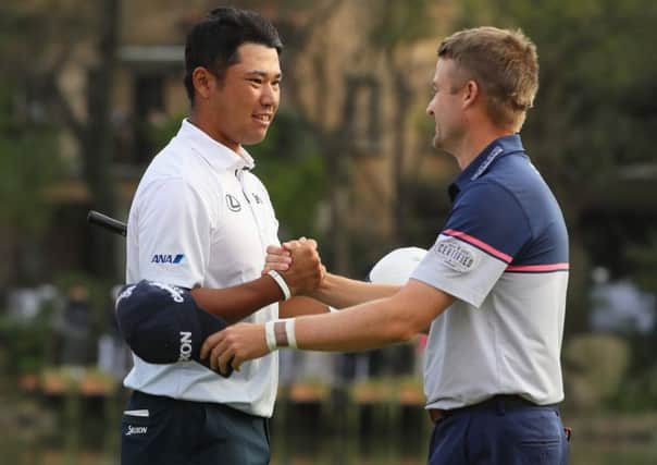 Hideki Matsuyama and Russell Knox shake hands on the 18th green during the final round of the WGC - HSBC Champions. Picture: Getty.