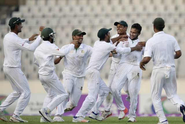 Team-mates congratulate Bangladesh's Shakib Al Hasan, second right, after the dismissal of England's Zafar Ansari on the third day of the second Test in Dhaka. Picture A M Ahad