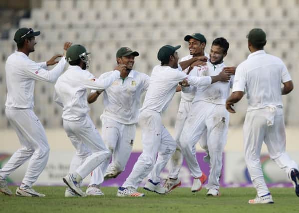Team-mates congratulate Bangladesh's Shakib Al Hasan, second right, after the dismissal of England's Zafar Ansari on the third day of the second Test in Dhaka. Picture A M Ahad