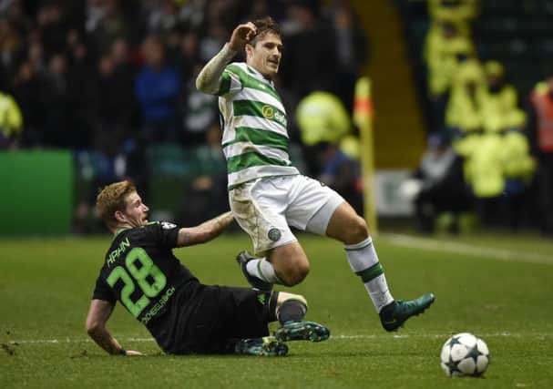 Andre Hahn, left, puts in a challenge on Erik Sviatchenko during the match at Celtic Park two weeks ago. Picture: SNS