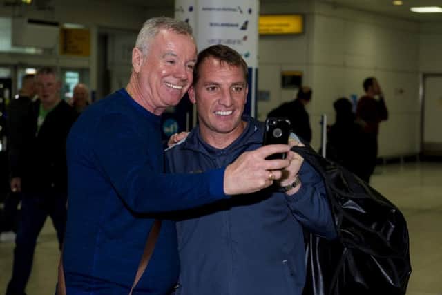 Celtic manager Brendan Rodgers with a fan at Glasgow Airport. Picture: SNS