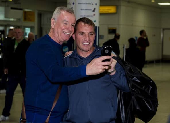 Celtic manager Brendan Rodgers with a fan at Glasgow Airport. Picture: SNS