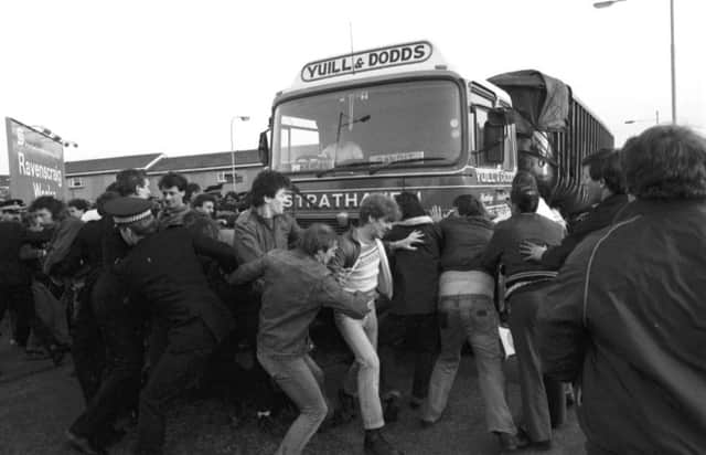 Members of the NUM miners' union picket line try to stop lorries delivering coal to Ravenscraig steelworks in May 1984
