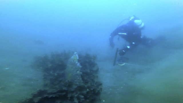 Underwater footage of a diver beside the floating church. Picture: SWNS