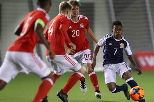 Scotland's Karamoko Dembele challenges Wales' Cavan Williams during the Victory Shield match at Oriam in Edinburgh. Picture: Andrew Milligan/PA Wire