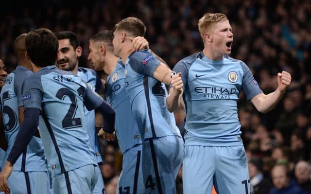 Kevin De Bruyne, right, celebrates after scoring Manchester City's second goal at the Etihad. Picture: AFP/Getty Images