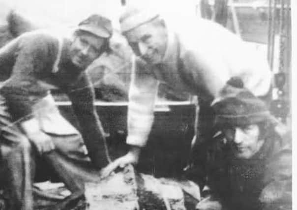 The turtle on board the Franchise with John Ritchie (centre) and Robert Warden (right). It is said it weight more than a tonne - and was five foot long from PIC Contributed.