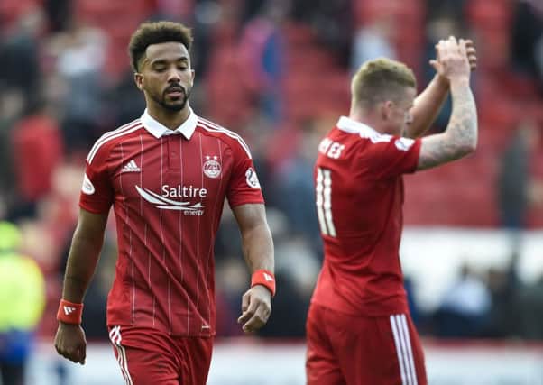 Shay Logan leaves the Pittodrie pitch after Saturday's defeat by Celtic which left Aberdeen ten points adrift in the title race. Picture: SNS