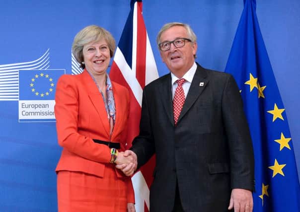 Theresa May, pictured with Jean-Claude Juncker, must now respond to Thursday's court setback. Picture: Thierry Charlier/AFP