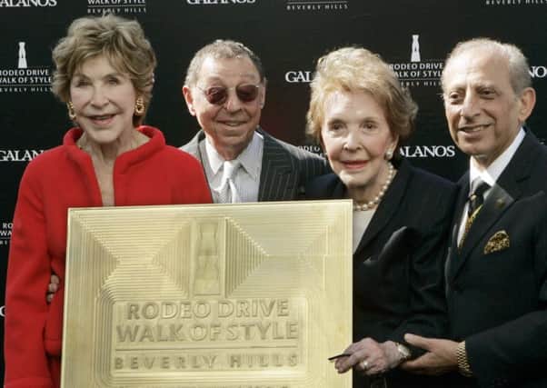 James Galanos, second left, is joined by Betsy Bloomingdale, left, former first lady Nancy Reagan and Mayor Jimmy Delshad. Picture: AP Photo/Reed Saxon