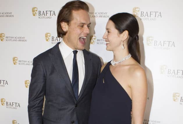 Stars of Outlander Sam Heughan and Caitriona Balfe on the red carpet at the BAFTA Scotland Awards. Picture: SWNS