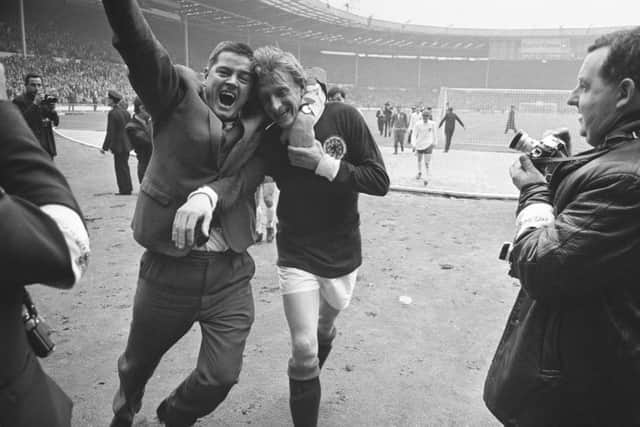 Denis Law is hugged by a fan after Scotland beat England 3-2 at Wembley in April 1967. Picture: Getty Images