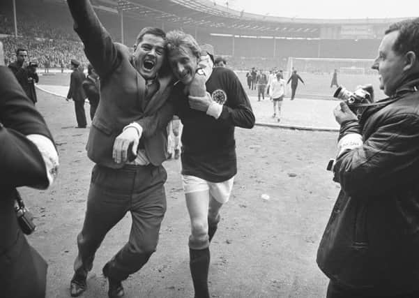 Denis Law is hugged by a fan after Scotland beat England 3-2 at Wembley in April 1967. Picture: Getty Images
