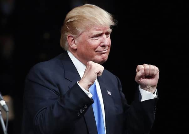 Republican presidential candidate Donald Trump gestures after speaking at a campaign rally. (AP Photo/John Bazemore)