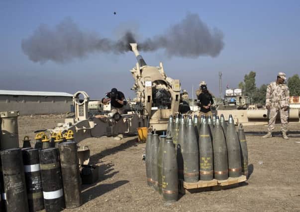 Iraqi army soldiers fire an artillery round at IS positions as Iraqi forces struggle to solidify gains in neighbourhoods in eastern Mosul. Picture: AP