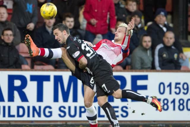 Head first: Dunfermlines Nicky Clark and Raiths Kyle Benedictus challenge for the ball.  Picture: Ian Rutherford