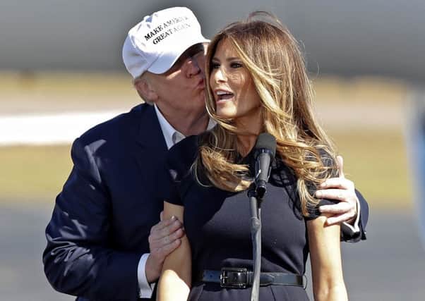 Republican presidential candidate Donald Trump kisses his wife Melania. (AP Photo/John Bazemore)