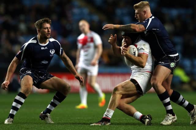 Jonny Lomax of England tackled by Danny Addy of Scotland during the Four Nations match at the Ricoh Arena. Picture: Nigel Roddis/Getty Images