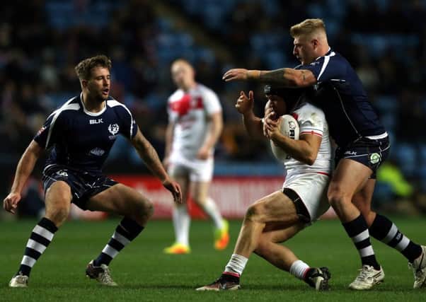 Jonny Lomax of England tackled by Danny Addy of Scotland during the Four Nations match at the Ricoh Arena.  Picture: Nigel Roddis/Getty Images